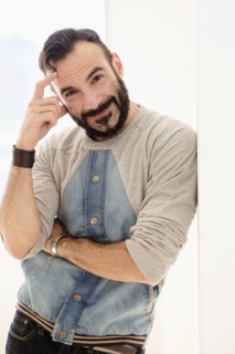 Portrait of man leaning on wall.