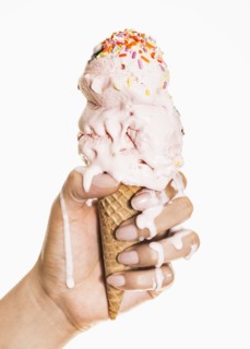 Female hand holding ice cream.