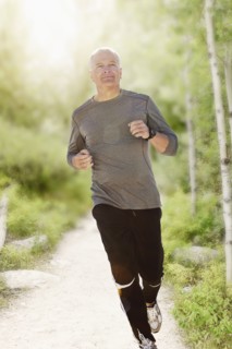 Man jogging on path in park.