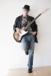 Portrait of cool man with bass guitar.