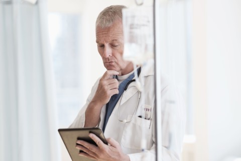 Doctor using tablet in hospital.
