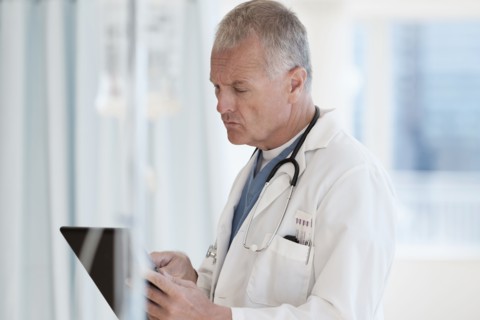 Doctor using tablet in hospital.