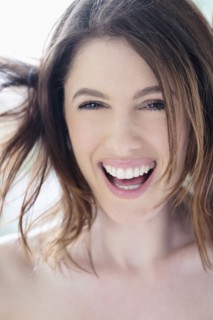 Portrait of beautiful woman with brown hair laughing.