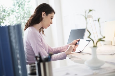 Young woman using digital tablet.