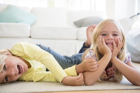 Boy (4-5) and girl (6-7) lying on floor