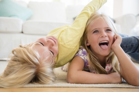 Boy (4-5) and girl (6-7) playing on floor