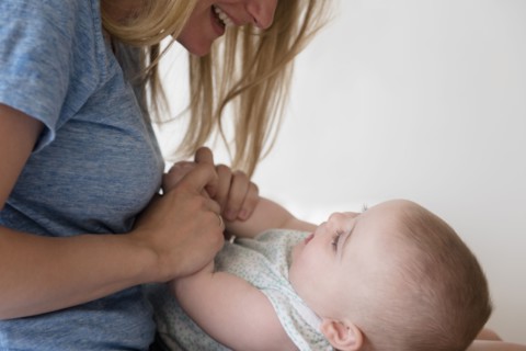 Mother holding hands of baby daughter (12-17 months)