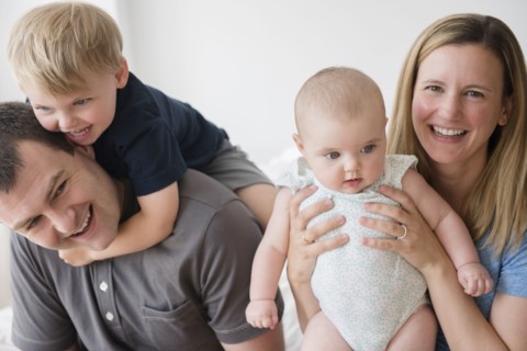 Portrait of parents with son (2-3) and baby daughter (12-17 months)