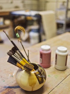 Brushes in bowl in art studio