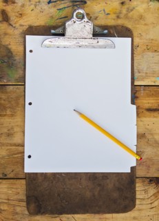 Pencil and clipboard with blank paper