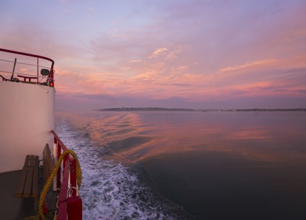 View from ferry towards sea at sunrise