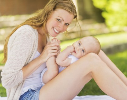 Mother holding baby (6-11 months) on lap