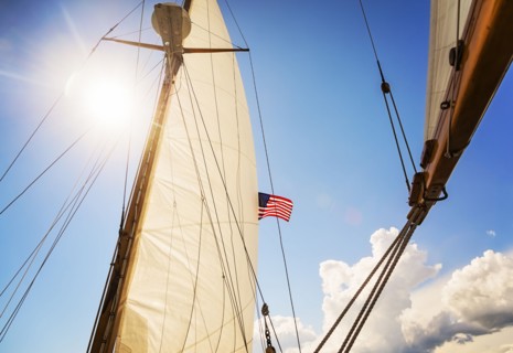 Close-up of sun shining through boat's sail