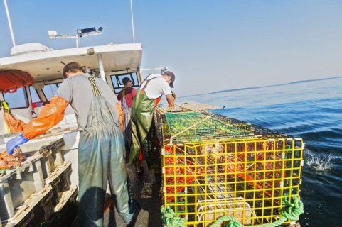 Three fishermen working on boat