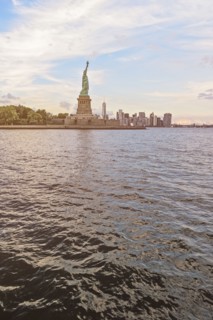 Statue of Liberty and financial district at dusk