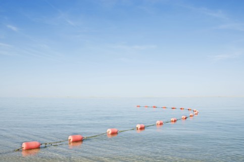 Rope with buoys on calm sea
