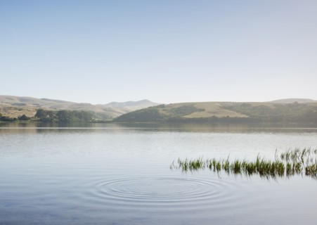 Lake by hills and clear sky