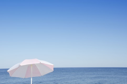 Sunshade against blue seascape