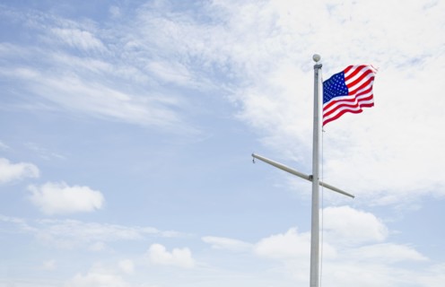 American flag against cloudy sky