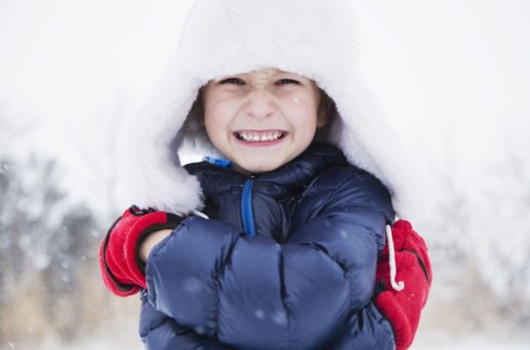 Portrait of boy (6-7) in fur hat and gloves