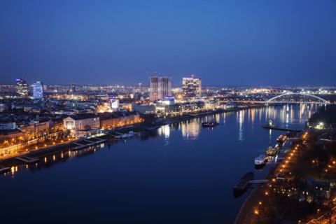 Illuminated cityscape and river at night