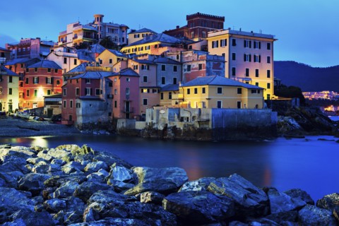 Boccadasse harbor with city at sunrise
