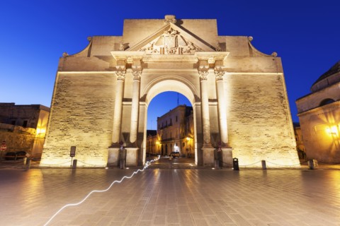Porta Napoli illuminated at dusk