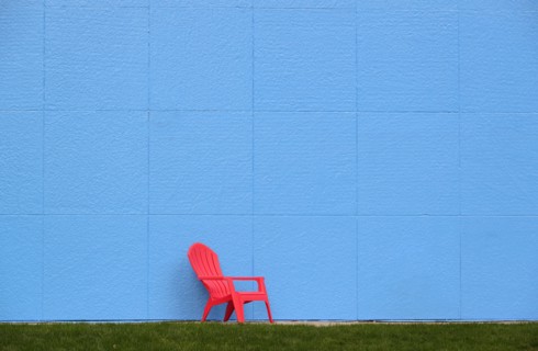 Red chair by blue wall