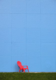 Red chair by blue wall