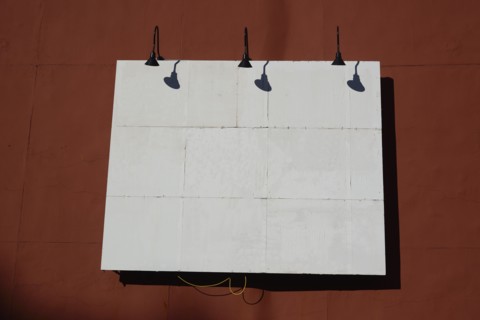 White billboard on red wall