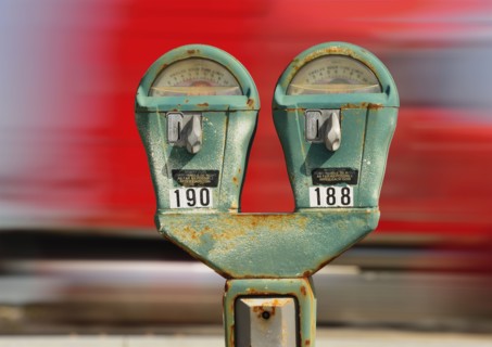 Old parking meter against panning transportation mode