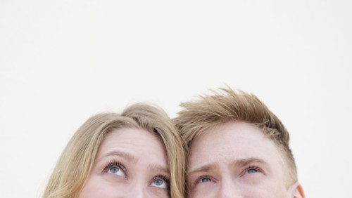 Young couple looking up.