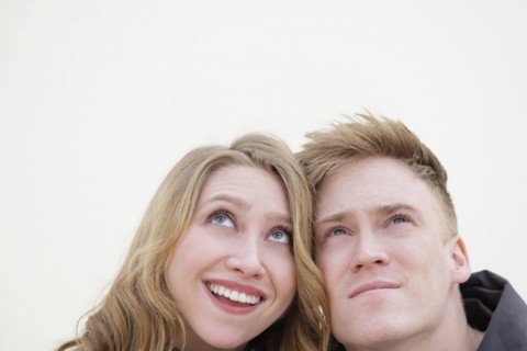 Young couple looking up.