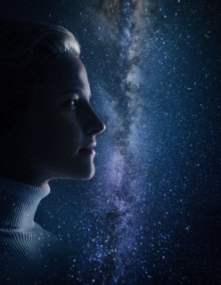 Studio shot of young woman looking at stars.