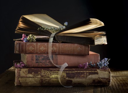 Stack of old books on table.