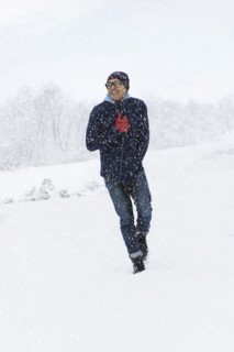 Mid adult man walking on snow. New York City, New York, USA.