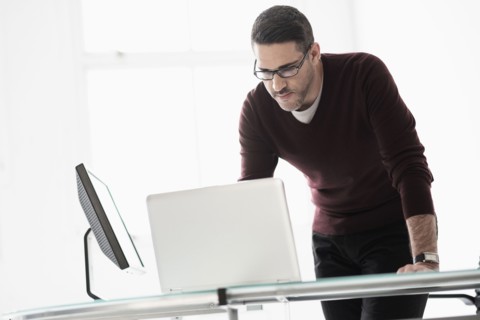 Man using laptop in office.