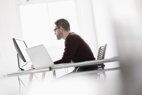 Man using computer in office.