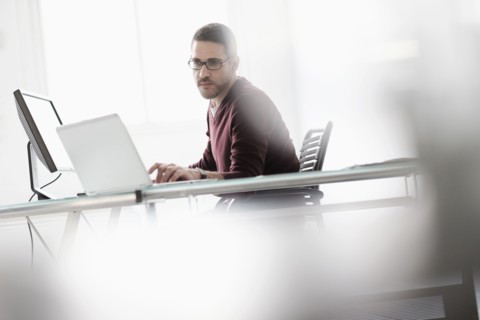 Man using laptop in office.