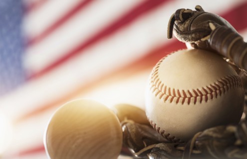 Close-up of baseball glove, ball and bat.