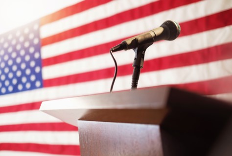 Lectern with American flag in background.
