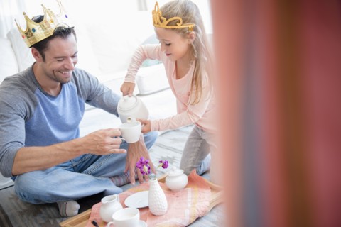 Daughter (6-7) having tea party with father