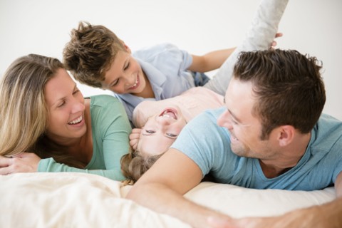 Family with two children (6-7, 8-9) in bedroom