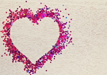 Confetti in shape of heart on wood