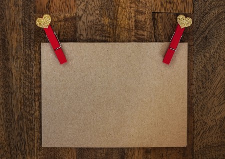 Blank paper with clothespin on wood