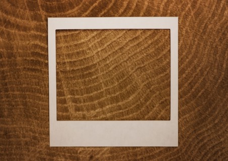 Empty Polaroid frame on wood