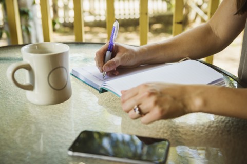 Young woman writing in diary