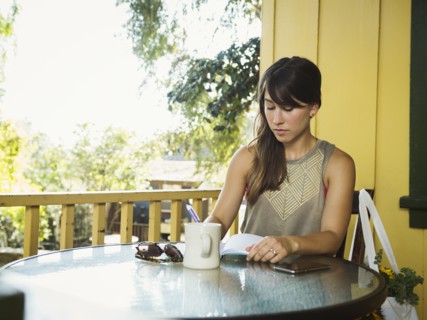 Young woman writing in diary