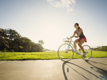 Young woman cycling in park