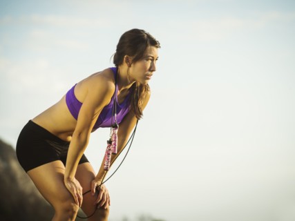 Young woman with jump rope resting